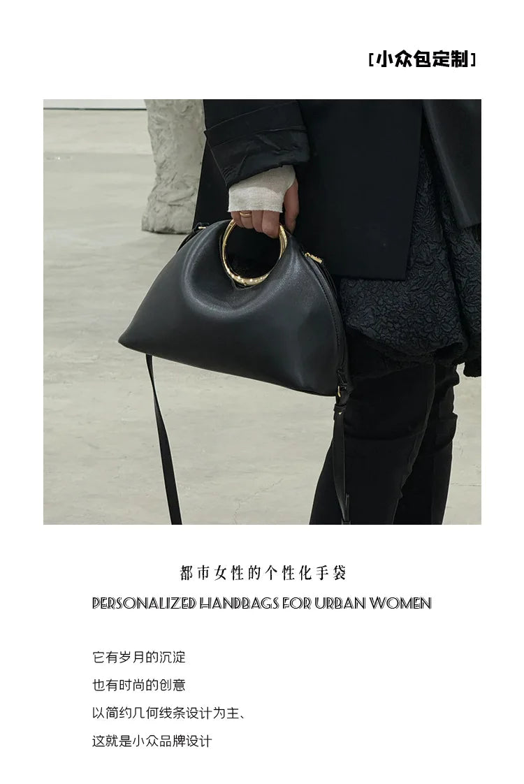 Luxury Sculpted Black Handbag with Gold Circular Handle – Modern Statement Top Handle Purse for Women